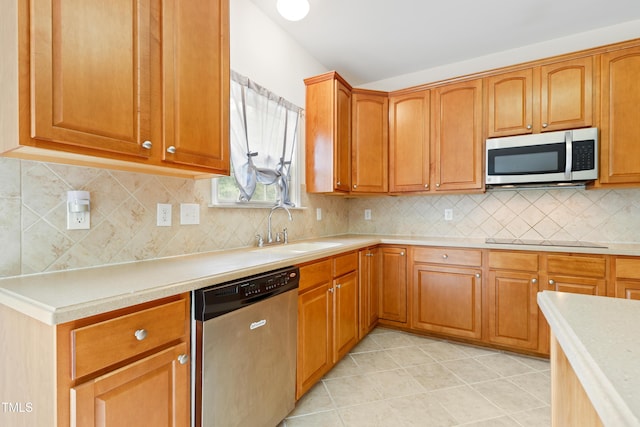 1405 Merrilow Ct, Wake Forest, NC 27587 - kitchen featuring appliances with stainless steel finishes, a sink, light countertops, light tile patterned floors, and decorative backsplash