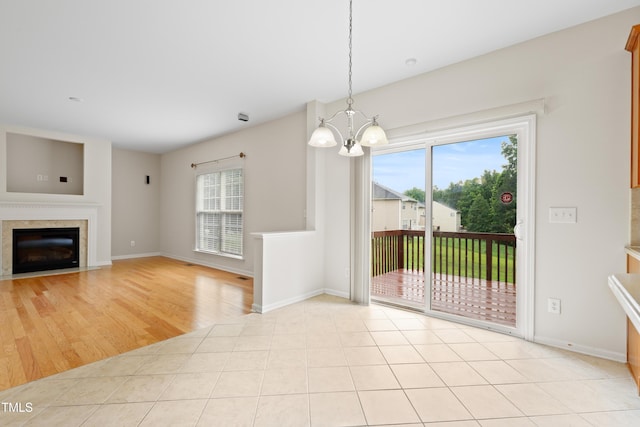1405 Merrilow Ct, Wake Forest, NC 27587 - unfurnished dining area featuring healthy amount of natural light, a chandelier, a fireplace with flush hearth, and baseboards