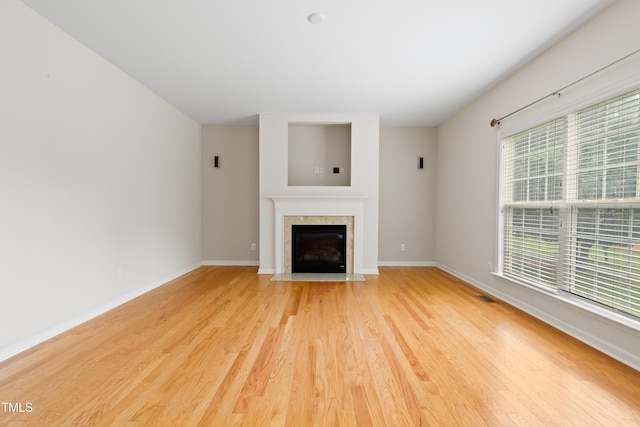 1405 Merrilow Ct, Wake Forest, NC 27587 - unfurnished living room with light wood finished floors, baseboards, and a fireplace with flush hearth
