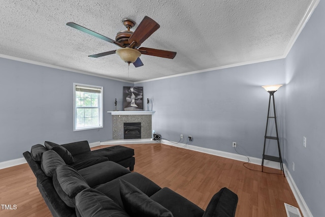 282 Cooke Rd, Louisburg, NC 27549 - living room with wood finished floors, ceiling fan, a tiled fireplace, a textured ceiling, and baseboards