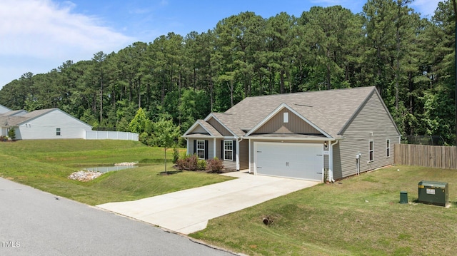145 Bounding Ln, Youngsville, NC 27596 - view of front facade featuring an attached garage, driveway, roof with shingles, board and batten siding, and a wooded view