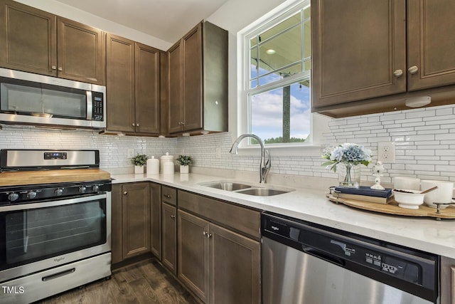 225 Rosewood Ln, Youngsville, NC 27596 - kitchen with stainless steel appliances, a sink, dark wood finished floors, and tasteful backsplash