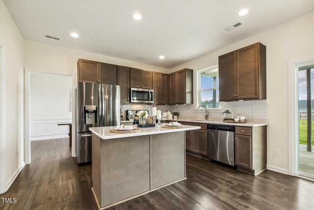 225 Rosewood Ln, Youngsville, NC 27596 - kitchen featuring appliances with stainless steel finishes, dark wood-style flooring, a sink, and recessed lighting
