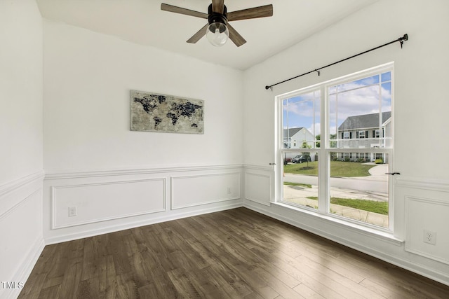 225 Rosewood Ln, Youngsville, NC 27596 - spare room with dark wood-type flooring, ceiling fan, wainscoting, and a decorative wall