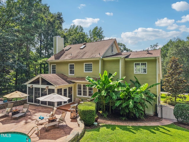 6829 Wood Forest Dr, Cary, NC 27519 - back of property with a patio area, a sunroom, a chimney, and a gate