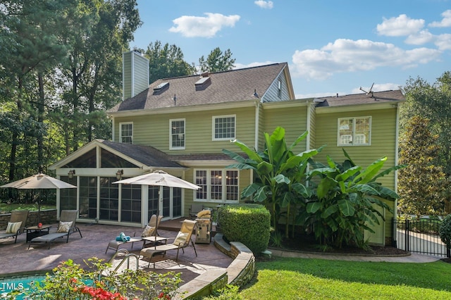 6829 Wood Forest Dr, Cary, NC 27519 - back of property with a patio area, a chimney, and a sunroom