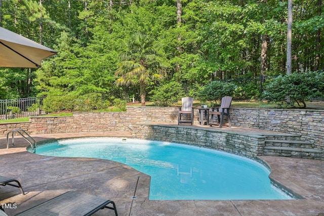 6829 Wood Forest Dr, Cary, NC 27519 - view of swimming pool featuring a patio and a wooded view