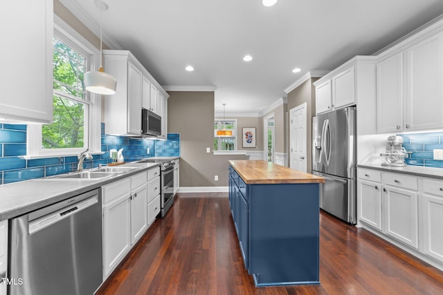 10579 Evergreen Spring Pl, Raleigh, NC 27614 - kitchen featuring stainless steel appliances, butcher block counters, crown molding, baseboards, and white cabinetry