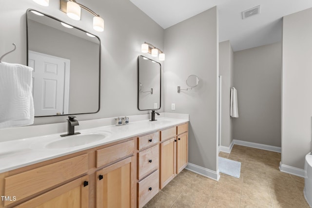 10579 Evergreen Spring Pl, Raleigh, NC 27614 - full bathroom with double vanity, a bathtub, baseboards, and tile patterned flooring
