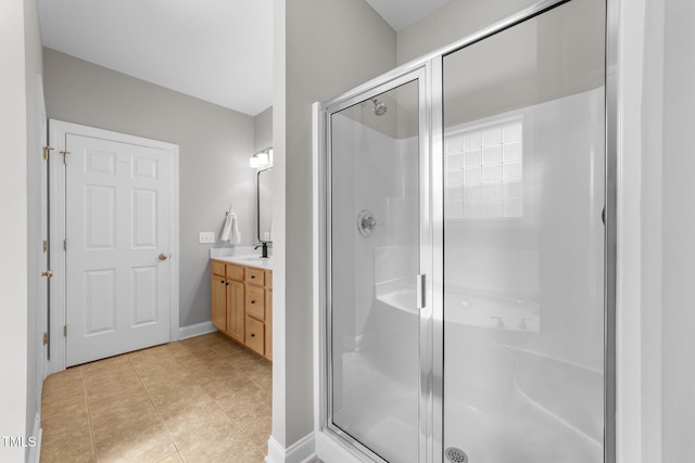 10579 Evergreen Spring Pl, Raleigh, NC 27614 - bathroom with vanity, a stall shower, tile patterned floors, and baseboards