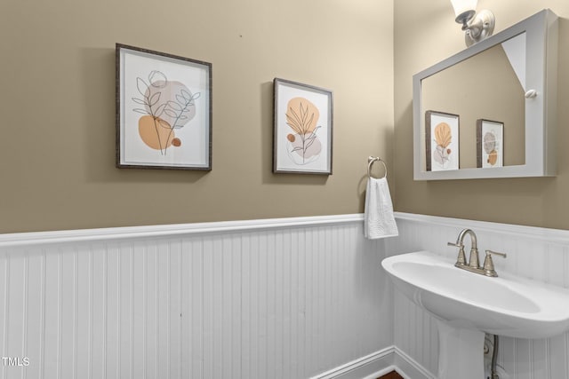 10579 Evergreen Spring Pl, Raleigh, NC 27614 - bathroom featuring a wainscoted wall and a sink