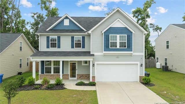 1712 Stackhouse Dr, Fayetteville, NC 28314 - view of front of house with a porch, brick siding, a garage, a front yard, and driveway