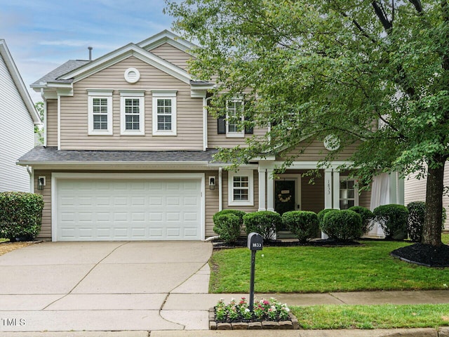 1833 Creek Oak Cir, Fuquay Varina, NC 27526 - view of front of property with driveway, a front lawn, an attached garage, and roof with shingles