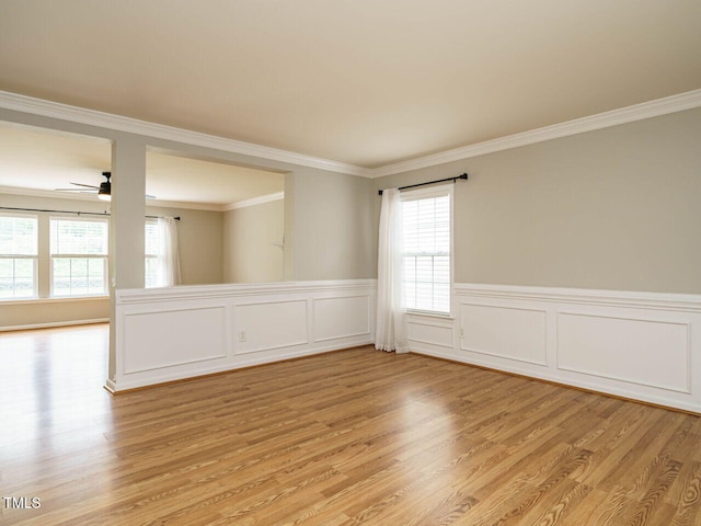 1833 Creek Oak Cir, Fuquay Varina, NC 27526 - unfurnished room with light wood finished floors, healthy amount of natural light, ornamental molding, a ceiling fan, and a wainscoted wall