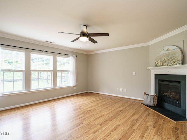 1833 Creek Oak Cir, Fuquay Varina, NC 27526 - unfurnished living room featuring light wood-type flooring, ceiling fan, crown molding, a fireplace with flush hearth, and baseboards