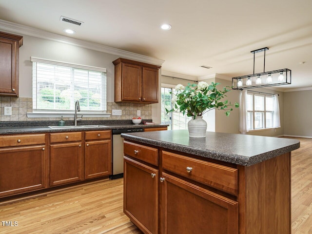1833 Creek Oak Cir, Fuquay Varina, NC 27526 - kitchen featuring a sink, dishwasher, dark countertops, healthy amount of natural light, and crown molding