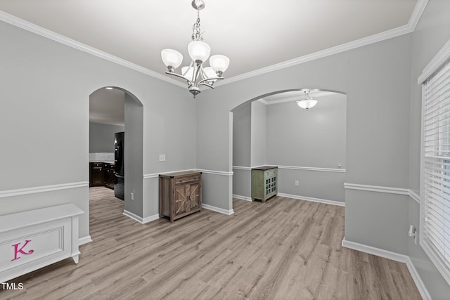 2709 Banks Lake Ct, Fuquay Varina, NC 27526 - spare room with arched walkways, a chandelier, light wood-type flooring, crown molding, and baseboards