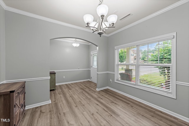 2709 Banks Lake Ct, Fuquay Varina, NC 27526 - empty room featuring arched walkways, wood finished floors, a chandelier, ornamental molding, and baseboards