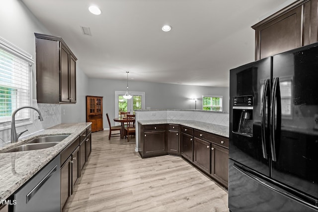 2709 Banks Lake Ct, Fuquay Varina, NC 27526 - kitchen featuring black fridge, a sink, dishwasher, decorative backsplash, and dark brown cabinetry