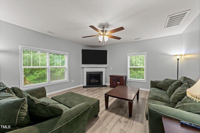 2709 Banks Lake Ct, Fuquay Varina, NC 27526 - living room featuring wood finished floors, ceiling fan, a fireplace with flush hearth, and baseboards