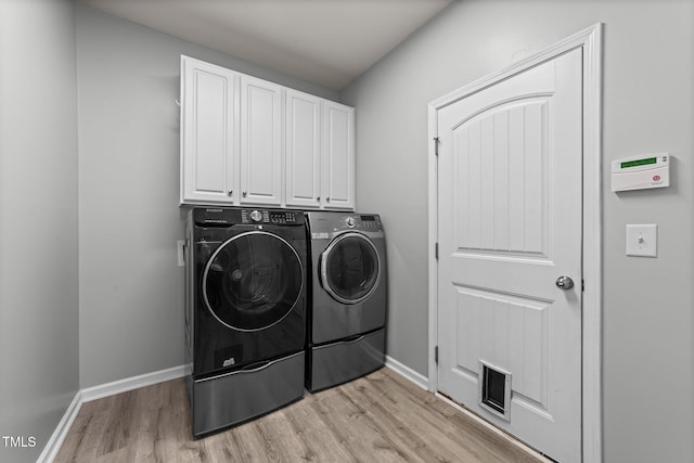 2709 Banks Lake Ct, Fuquay Varina, NC 27526 - washroom with washer and dryer, cabinet space, light wood finished floors, and baseboards