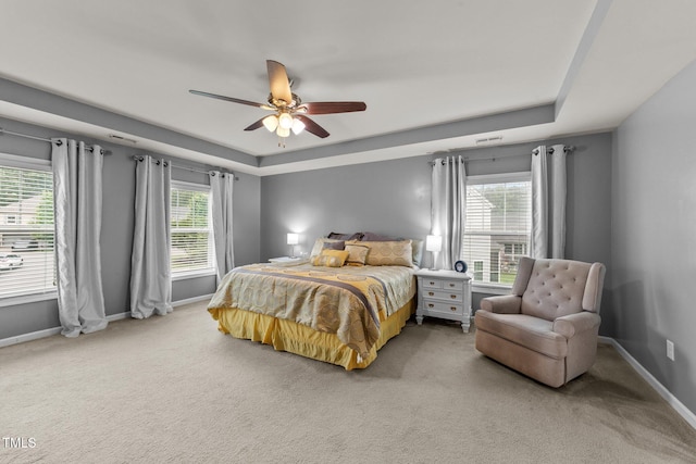 2709 Banks Lake Ct, Fuquay Varina, NC 27526 - bedroom featuring a raised ceiling, carpet floors, baseboards, and a ceiling fan