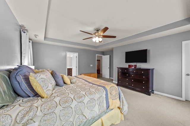 2709 Banks Lake Ct, Fuquay Varina, NC 27526 - bedroom featuring baseboards, carpet flooring, a raised ceiling, ceiling fan, and ensuite bath