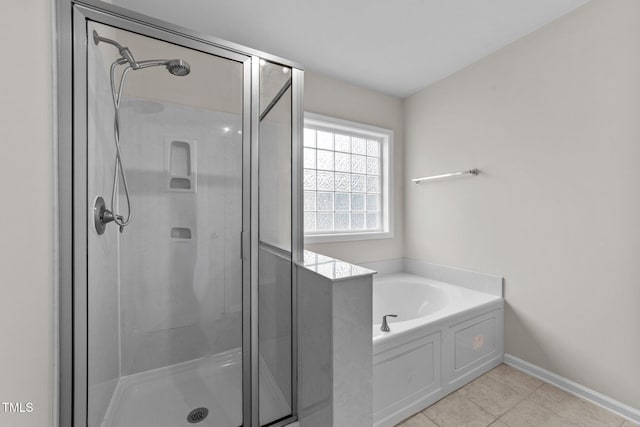 2709 Banks Lake Ct, Fuquay Varina, NC 27526 - bathroom featuring a stall shower, a bath, tile patterned flooring, and baseboards