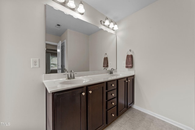 2709 Banks Lake Ct, Fuquay Varina, NC 27526 - bathroom with double vanity, tile patterned flooring, and baseboards