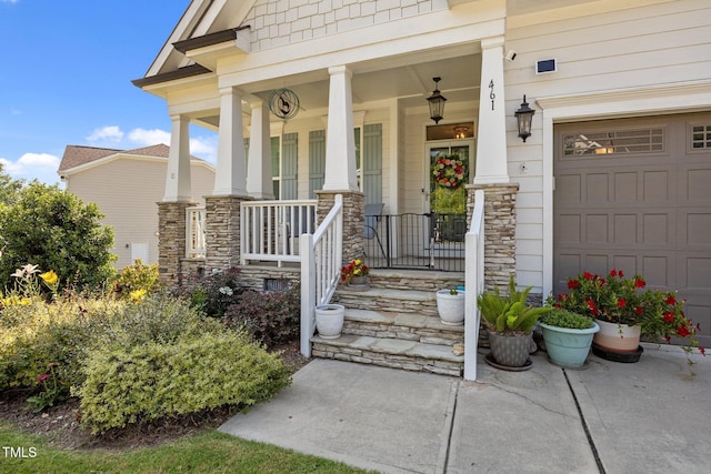 461 Cedar Pond Ct, Knightdale, NC 27545 - property entrance with covered porch, stone siding, and a garage