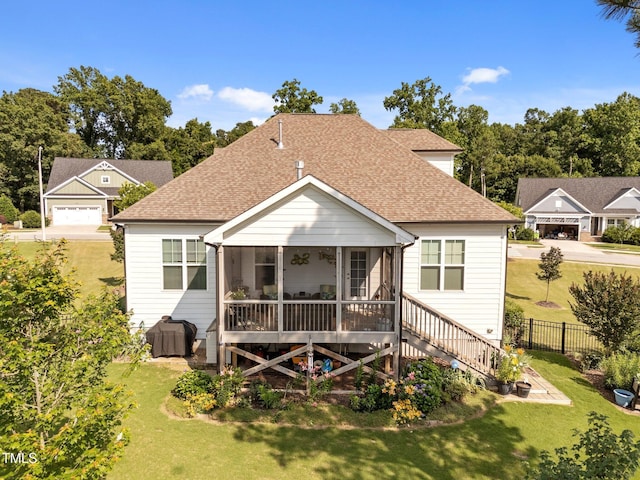 461 Cedar Pond Ct, Knightdale, NC 27545 - back of house with a shingled roof, a sunroom, and stairway
