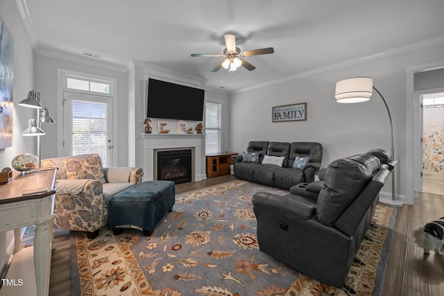 461 Cedar Pond Ct, Knightdale, NC 27545 - living room featuring wood finished floors, crown molding, a ceiling fan, a glass covered fireplace, and baseboards