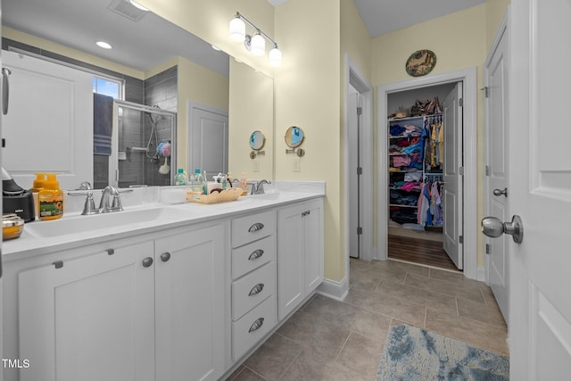 461 Cedar Pond Ct, Knightdale, NC 27545 - full bathroom featuring a stall shower, double vanity, a walk in closet, tile patterned floors, and baseboards