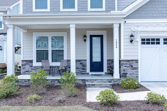 1950 Menet St, Apex, NC 27502 - property entrance with covered porch, stone siding, and a garage