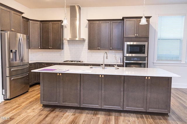 1950 Menet St, Apex, NC 27502 - kitchen with stainless steel appliances, wall chimney range hood, a sink, dark brown cabinets, and light wood-type flooring