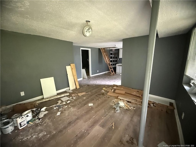 209 Rose St, Spring Lake, NC 28390 - unfurnished living room with a textured ceiling, baseboards, stairs, and wood finished floors