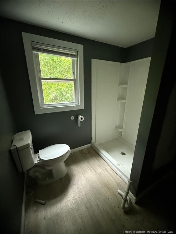 209 Rose St, Spring Lake, NC 28390 - bathroom featuring toilet, a shower stall, wood finished floors, and baseboards