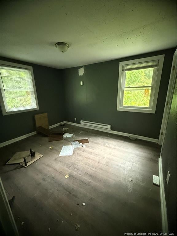 209 Rose St, Spring Lake, NC 28390 - unfurnished bedroom featuring a baseboard radiator, multiple windows, and baseboards