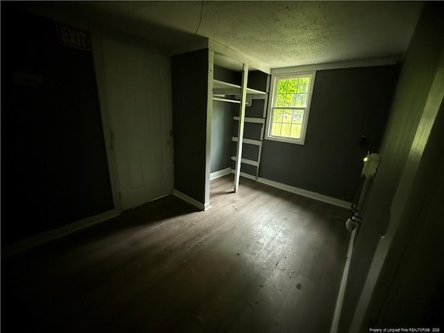 209 Rose St, Spring Lake, NC 28390 - unfurnished bedroom featuring a textured ceiling, wood finished floors, and baseboards