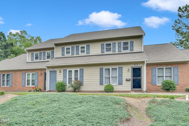 2602 Hitchcock Dr, Durham, NC 27705 - view of property with brick siding, a front yard, and a shingled roof