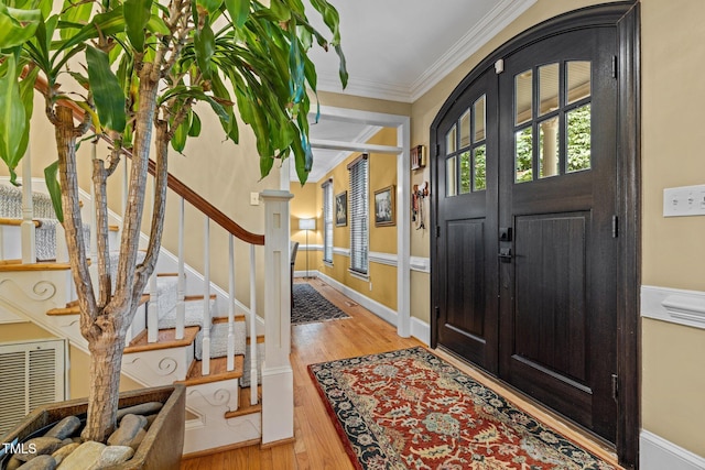 1501 Chatsworth Ln, Raleigh, NC 27614 - entrance foyer with ornamental molding, wood finished floors, baseboards, and stairway