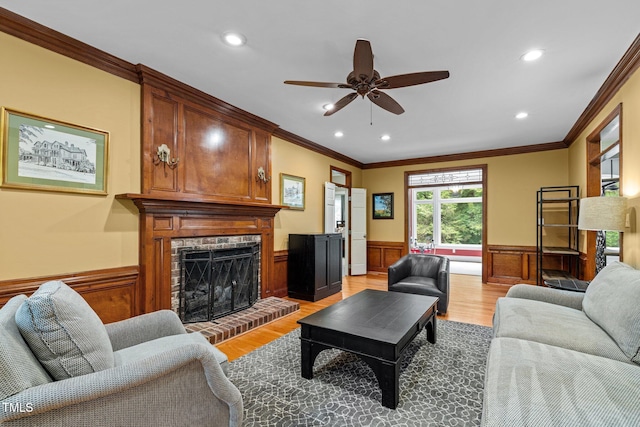 1501 Chatsworth Ln, Raleigh, NC 27614 - living room with a wainscoted wall, ornamental molding, recessed lighting, light wood-style flooring, and ceiling fan
