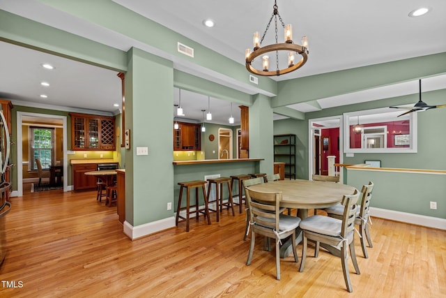 1501 Chatsworth Ln, Raleigh, NC 27614 - dining space featuring recessed lighting, a chandelier, light wood-style floors, baseboards, and bar