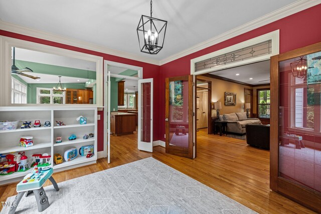 1501 Chatsworth Ln, Raleigh, NC 27614 - recreation room with a chandelier, crown molding, wood finished floors, and baseboards