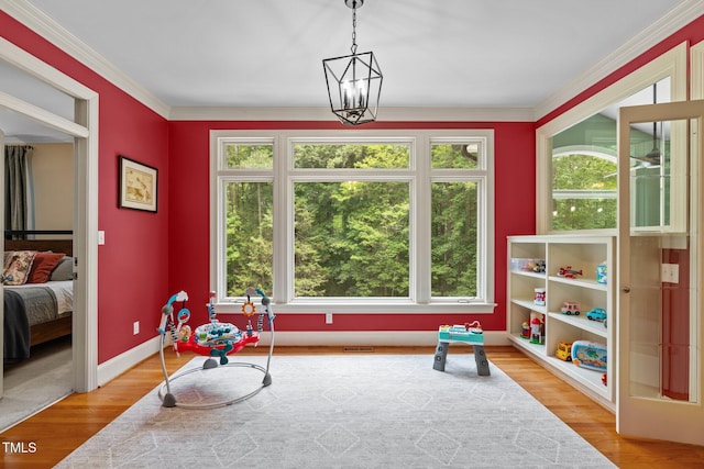 1501 Chatsworth Ln, Raleigh, NC 27614 - playroom featuring healthy amount of natural light, wood finished floors, baseboards, and crown molding