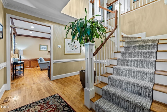 1501 Chatsworth Ln, Raleigh, NC 27614 - stairs featuring wood finished floors, crown molding, a wainscoted wall, and recessed lighting