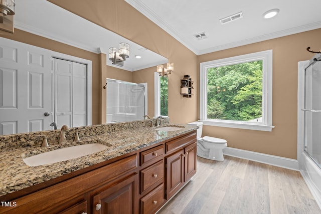 1501 Chatsworth Ln, Raleigh, NC 27614 - bathroom with crown molding, a chandelier, baseboards, double vanity, and toilet