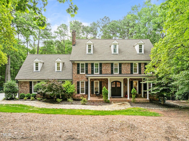1501 Chatsworth Ln, Raleigh, NC 27614 - view of front of home with brick siding, a porch, a chimney, and a shingled roof