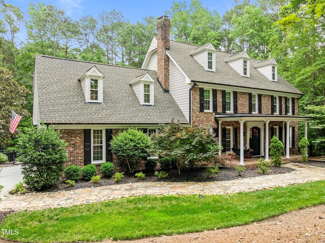 1501 Chatsworth Ln, Raleigh, NC 27614 - view of front of home featuring brick siding, a porch, roof with shingles, and a chimney