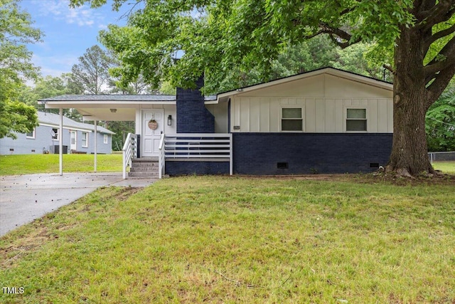 2752 Weldon Ter, Durham, NC 27703 - view of front of home featuring an attached carport, driveway, brick siding, crawl space, and a front yard
